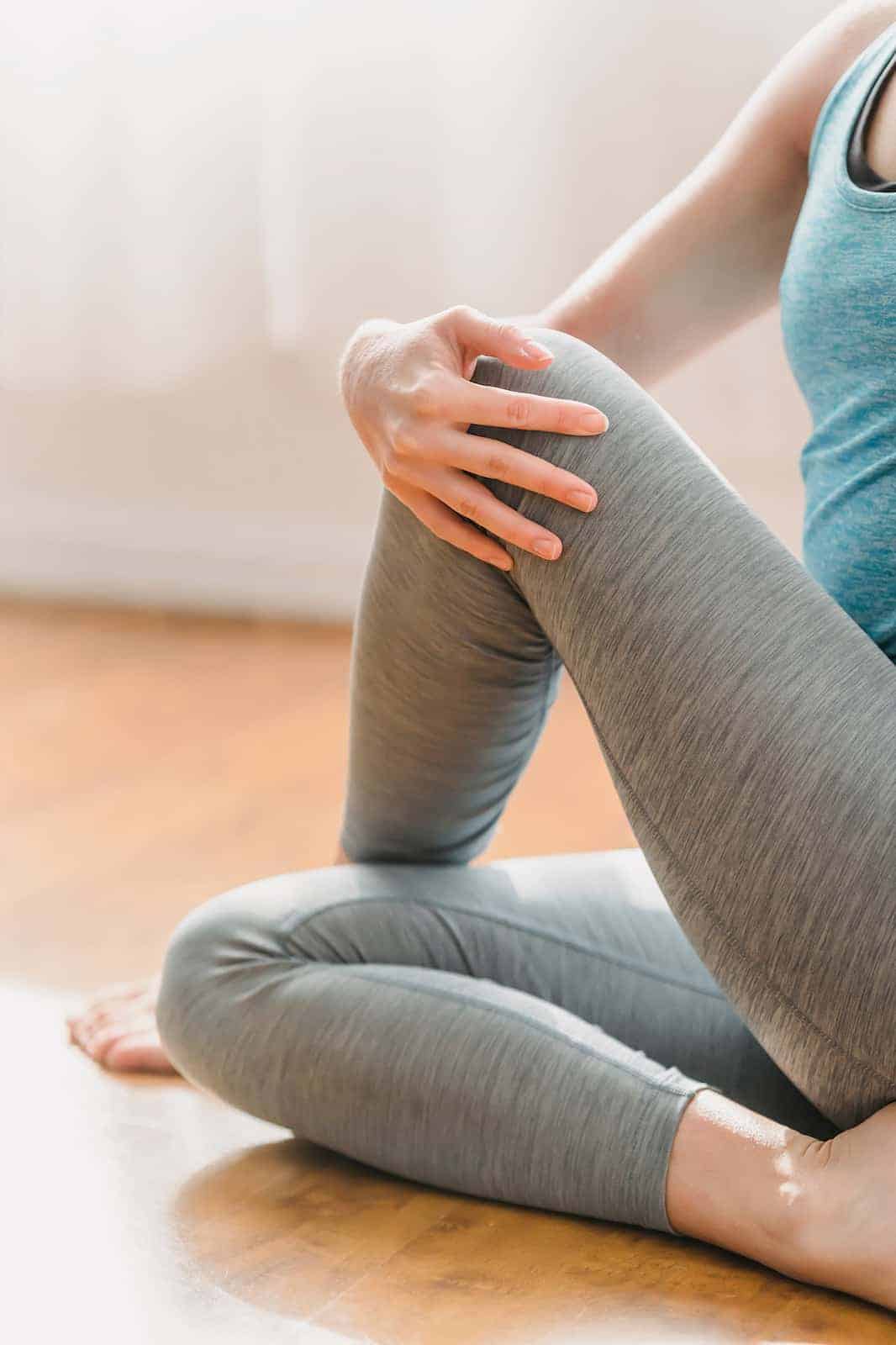 woman doing leg stretches on floor